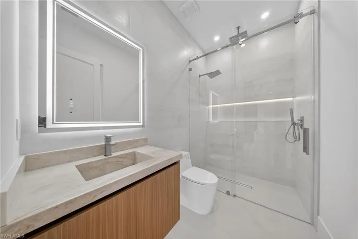 Full bath featuring vanity and a stall shower
