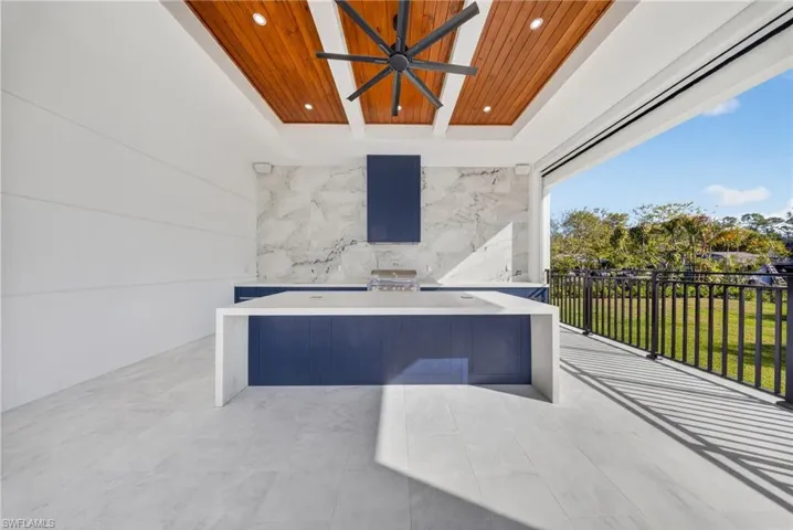 View of patio with a ceiling fan and exterior kitchen