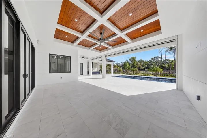 View of patio / terrace featuring a ceiling fan and an outdoor pool