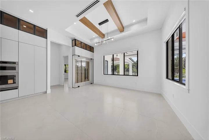Unfurnished room with healthy amount of natural light and recessed lighting