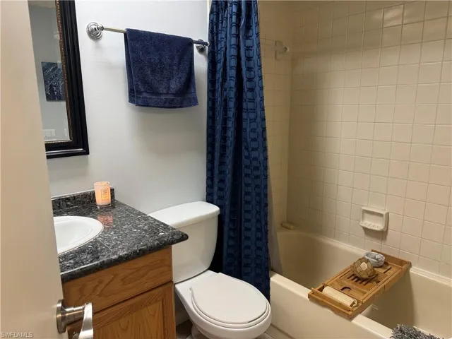 Full bathroom with vanity, toilet, and shower / tub combo