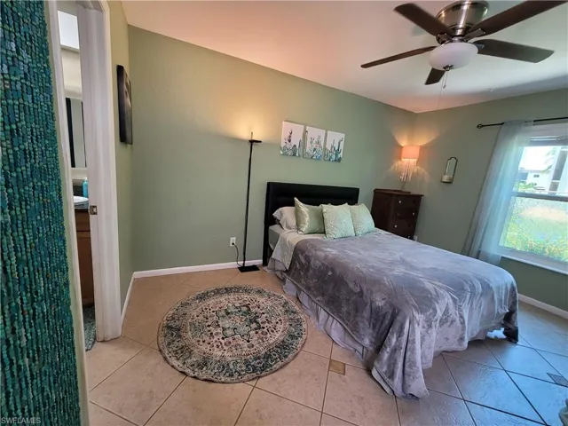 Tiled bedroom with ceiling fan