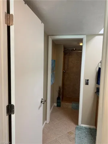 Hallway with light tile patterned floors