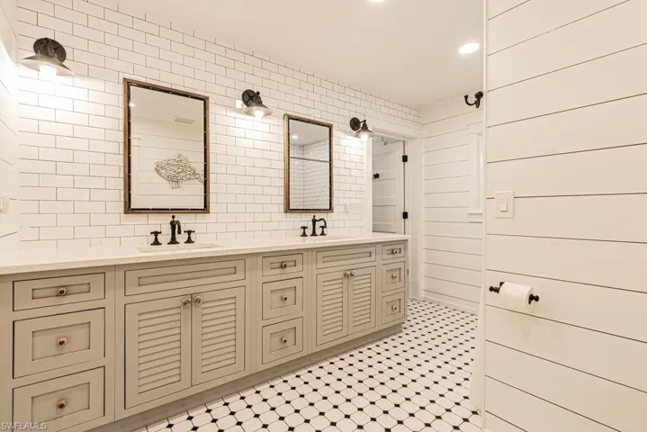 Full bathroom with tasteful backsplash, double vanity, and recessed lighting