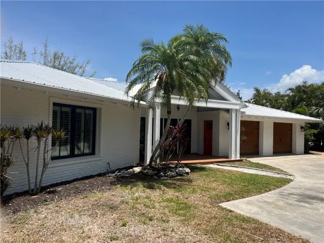 View of front of home with concrete driveway, brick siding, and a garage