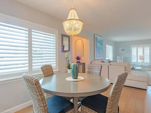 Dining space with a chandelier and light wood-type flooring