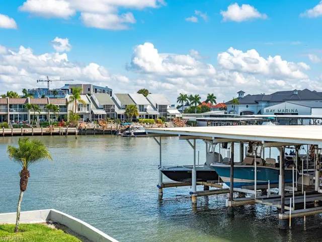 Dock area featuring boat lift and a water view