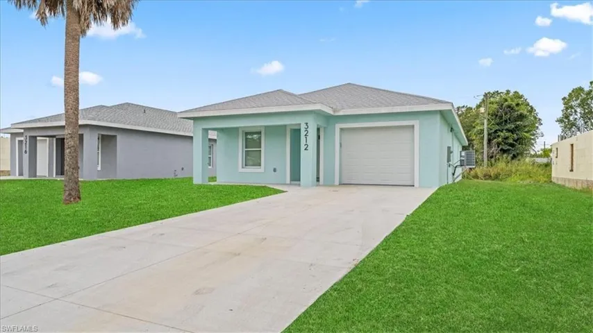 Single story home featuring stucco siding, a front lawn, concrete driveway, and a garage
