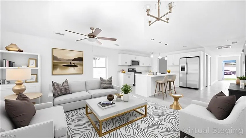 Living room featuring a ceiling fan and a chandelier