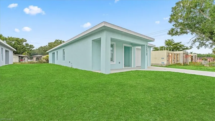 Back of house featuring stucco siding and driveway