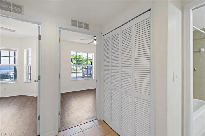 Hallway with light hardwood / wood-style flooring