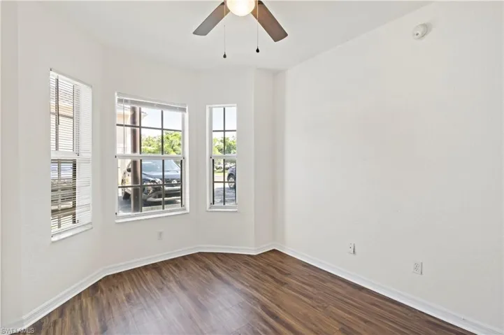 Spare room with ceiling fan and hardwood / wood-style flooring