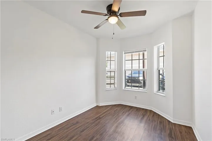 Spare room with ceiling fan and wood-type flooring