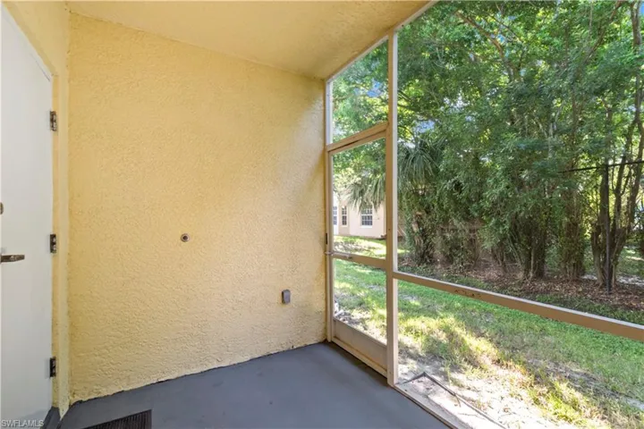 Unfurnished sunroom featuring lofted ceiling