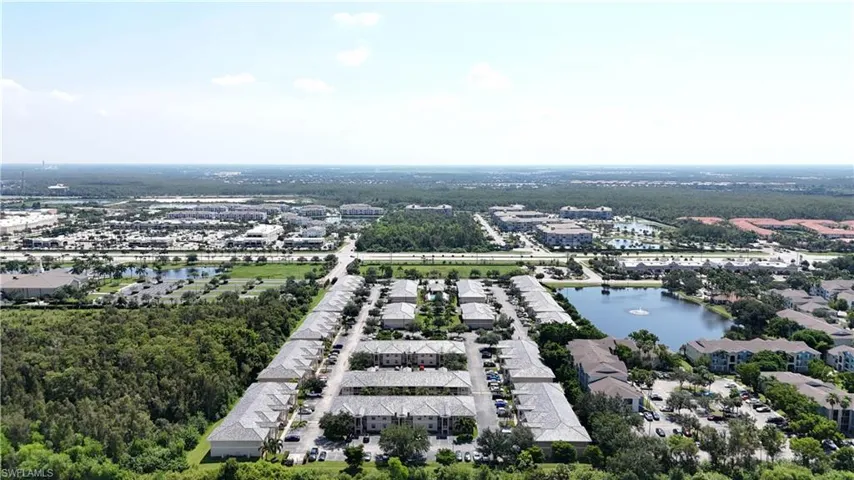 Birds eye view of property with a water view