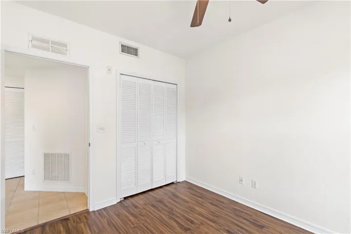 Unfurnished bedroom with a closet, ceiling fan, and hardwood / wood-style flooring