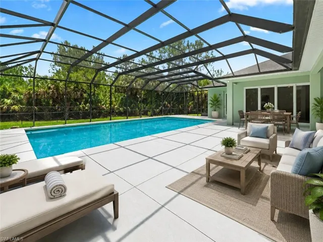 Expansive screened lanai featuring a swimming pool, spacious paved patio, and multiple sliding glass doors opening to the interior