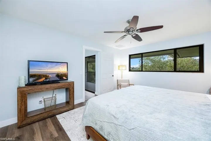 Bedroom with dark wood-type flooring and ceiling fan