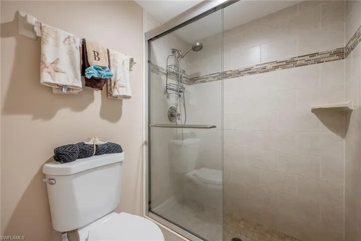 Bathroom with toilet and a shower with shower door