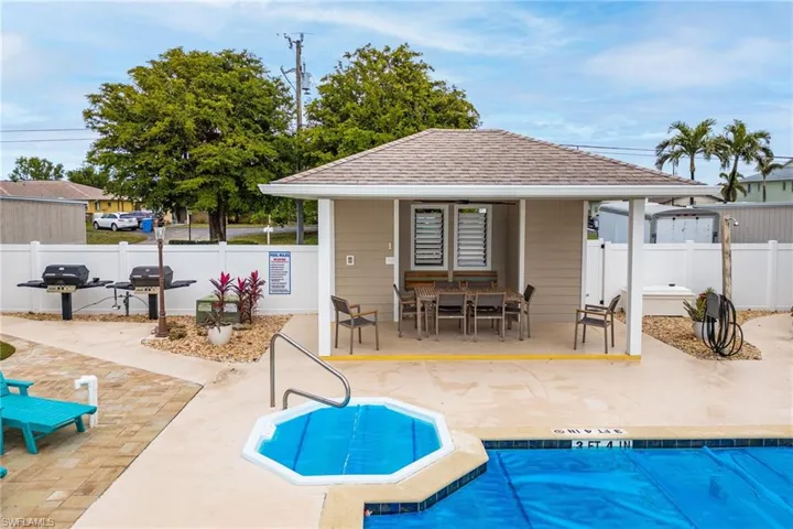 View of swimming pool with a patio and grilling area