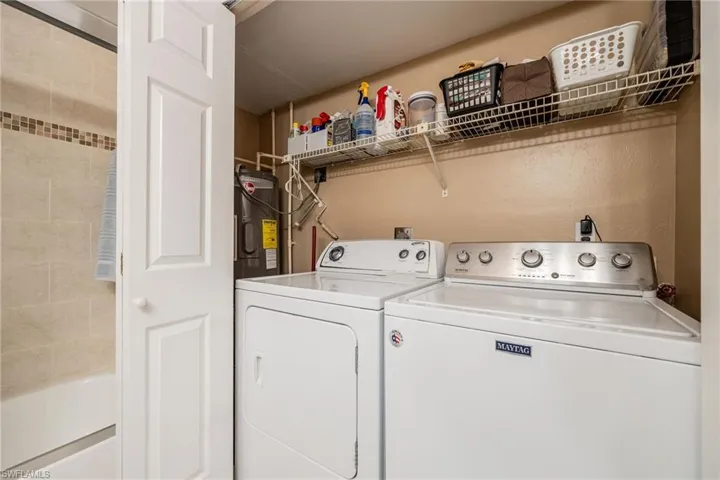 Laundry area featuring water heater and independent washer and dryer
