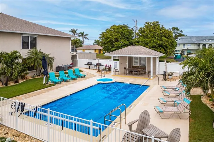 View of swimming pool featuring an outbuilding and a patio