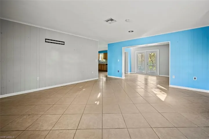 Living room featuring wood walls and crown molding