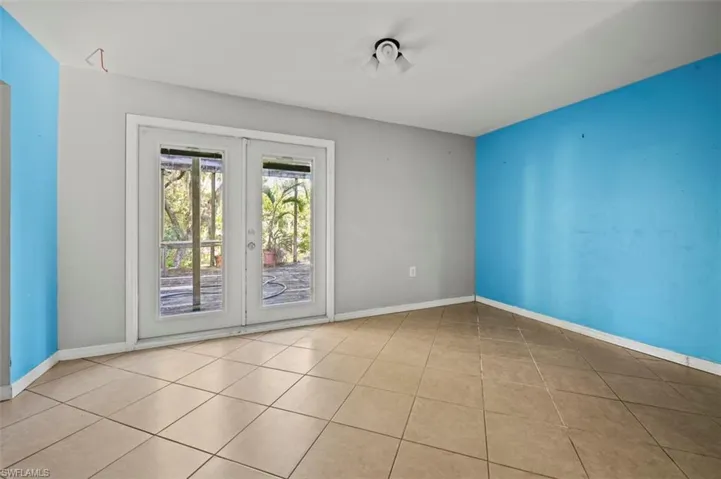 Tiled dinning room with french doors