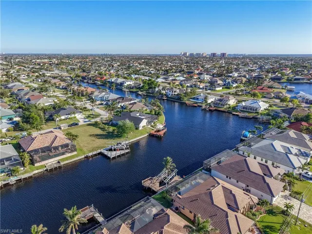Aerial view of residential area featuring a large body of water