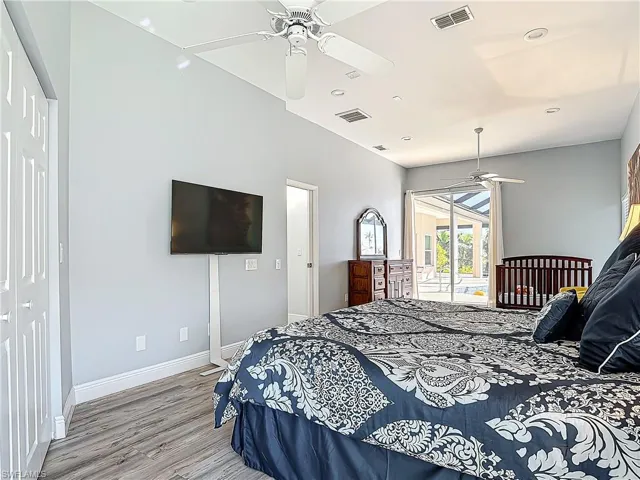 Bedroom with access to outside, ceiling fan, wood finished floors, and recessed lighting