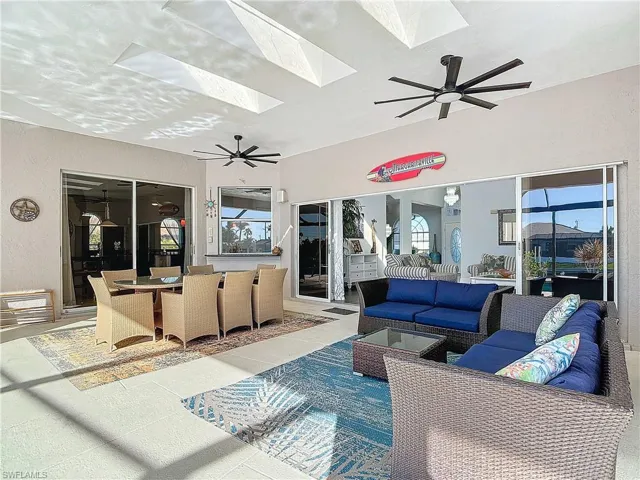 View of patio with ceiling fan, outdoor dining space, and outdoor lounge area