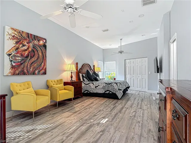 Bedroom featuring a ceiling fan, a closet, and light wood finished floors