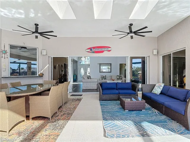 Living area featuring a ceiling fan, a skylight, and healthy amount of natural light