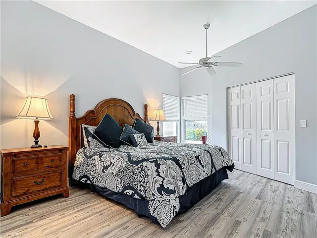 Bedroom featuring light wood-type flooring, a closet, and ceiling fan
