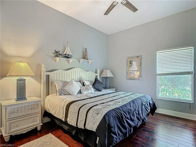 Bedroom with dark wood-style flooring and ceiling fan