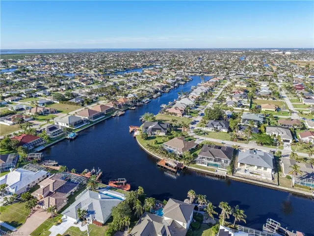 Aerial view of property's location featuring nearby suburban area and a nearby body of water