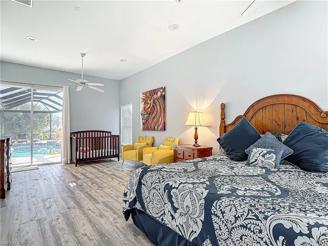 Bedroom featuring wood finished floors, access to outside, a sunroom, and recessed lighting