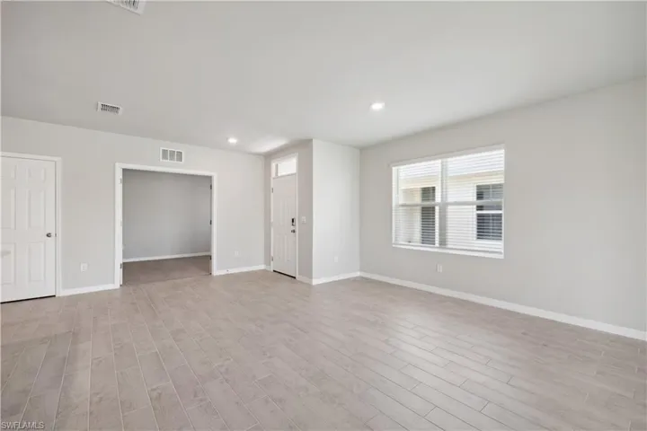 Empty room with light hardwood / wood-style floors