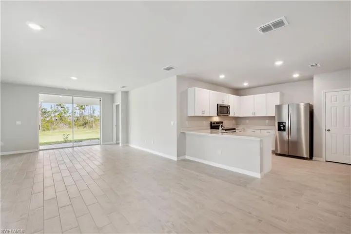 Kitchen with white cabinetry, stainless steel appliances, and kitchen peninsula