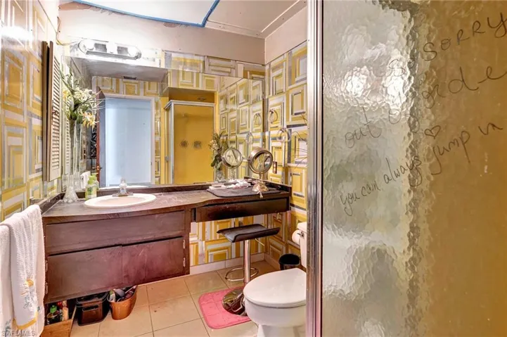 Bathroom featuring tile flooring, toilet, and vanity