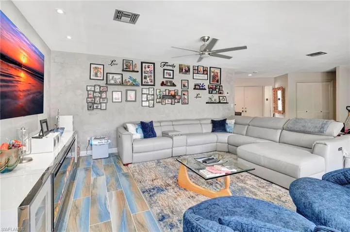 Living room featuring wood-type flooring and ceiling fan