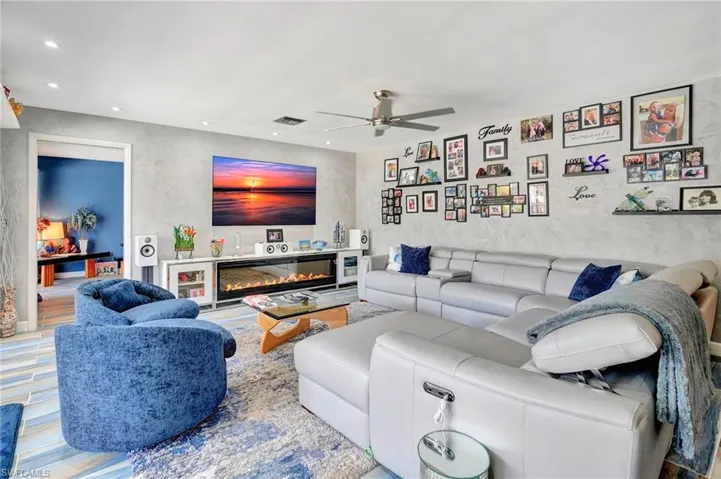 Living room featuring ceiling fan and hardwood / wood-style flooring