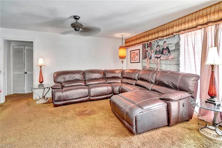 Living room with ceiling fan and carpet flooring