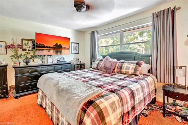 Carpeted bedroom with ceiling fan