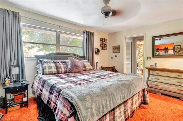 Bedroom with ceiling fan and carpet floors