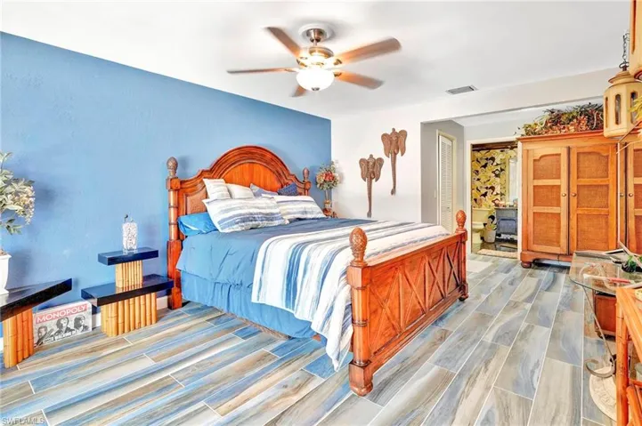 Bedroom with ceiling fan and light hardwood / wood-style flooring