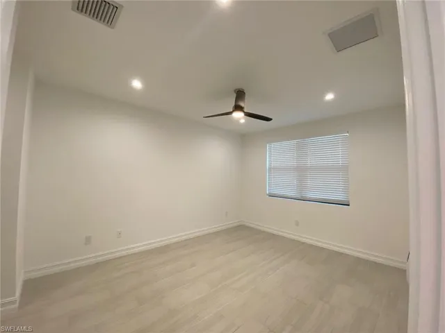 Room featuring light-toned tile flooring, recessed ceiling lighting, a modern ceiling fan, and a window with horizontal blinds