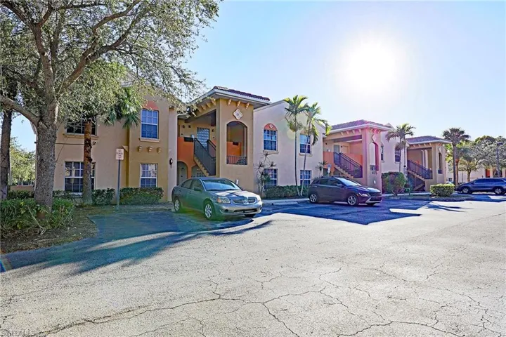 View of property featuring uncovered parking