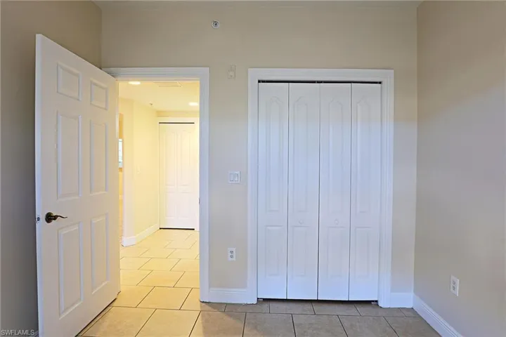 Unfurnished bedroom with light tile patterned floors and a closet