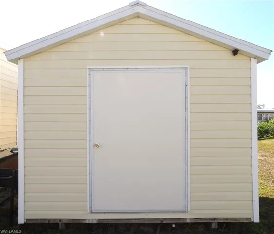 Back of house with a yard